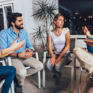 Photo of people discussing together around a circle for Dialectical Behaviour Therapy workshop