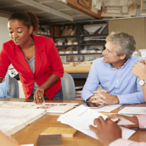 People working on a plan around a table for Emergency Planning Workshop