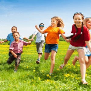 Photo of a group of happy children running through field for Resilience and Children workshop