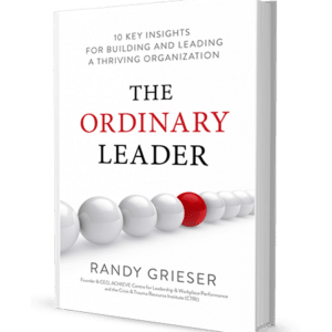 Book mockup of "The Ordinary Leader: 10 Key Insights for Building and Leading a Thriving Organization" by Randy Grieser, founder and CEO of ACHIEVE and CTRI. The cover features a row of white shiny orbs, with one of them being red instead.