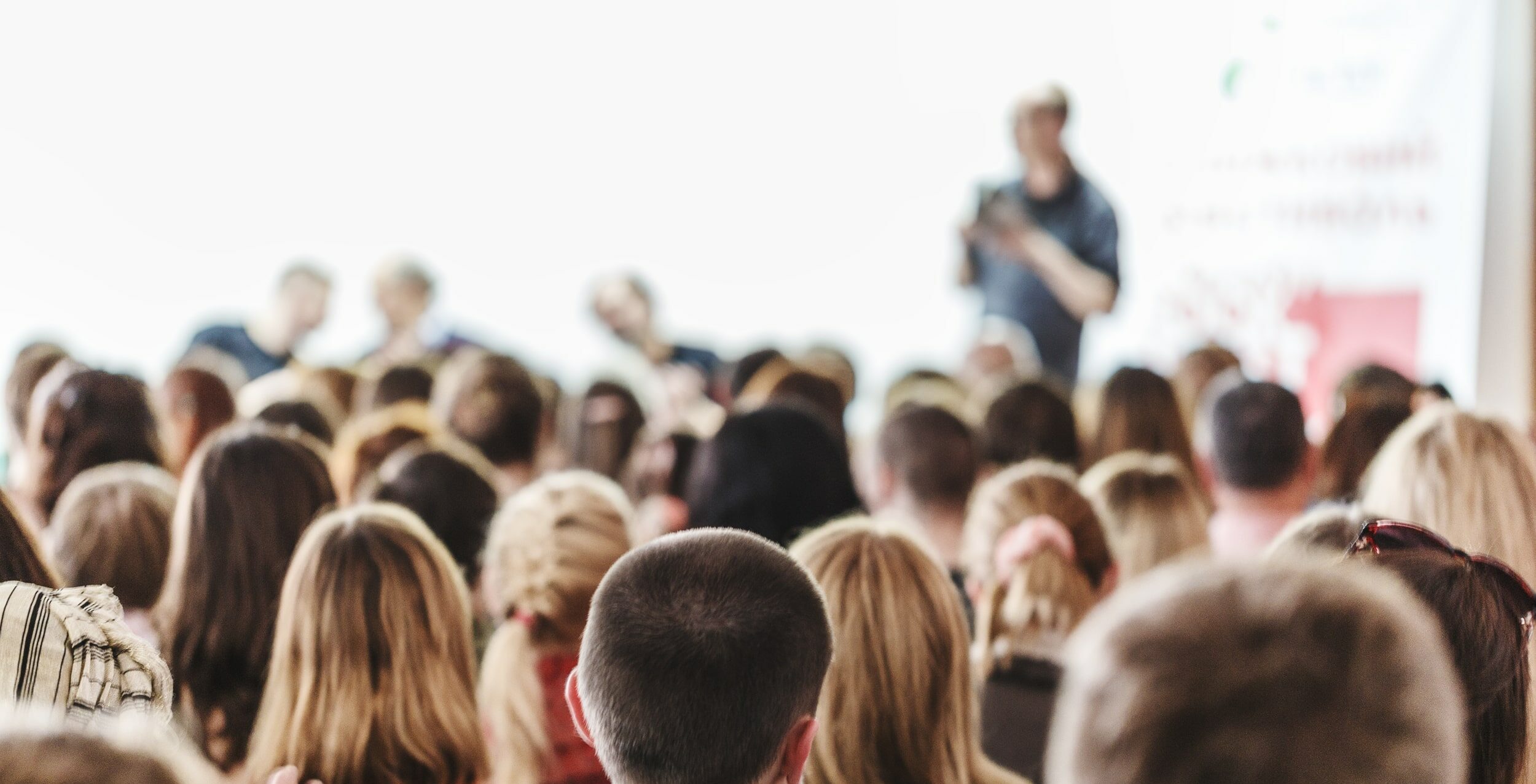 Photo of a large crowd of people listening to a presenter at a CTRI workshop.